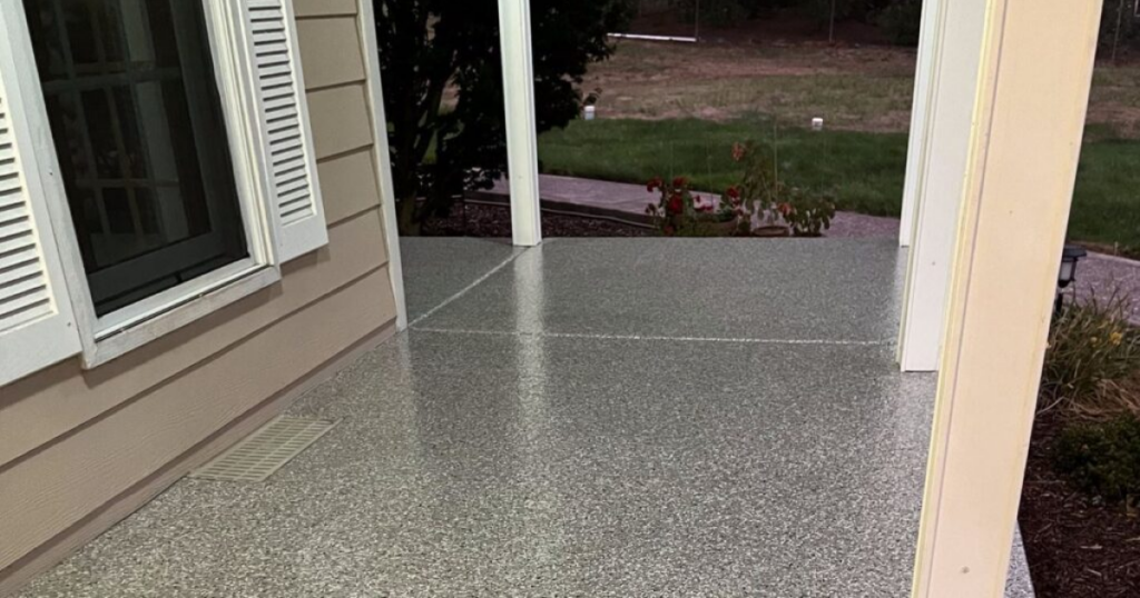 Residential covered patio with gray flake concrete floor coating in Camas WA